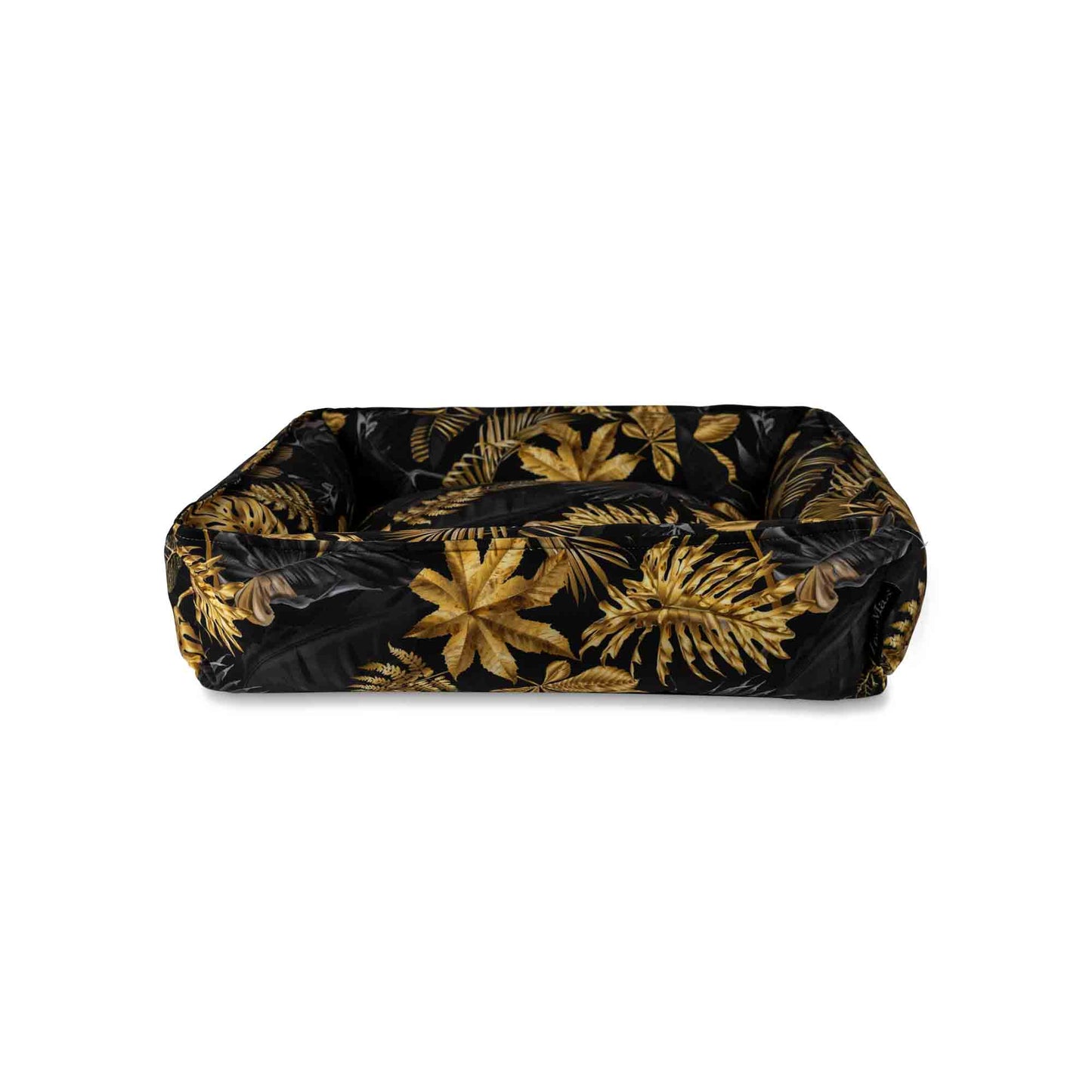 Voorkant hondenmand met tropische bladeren print in zwart en goudtinten.